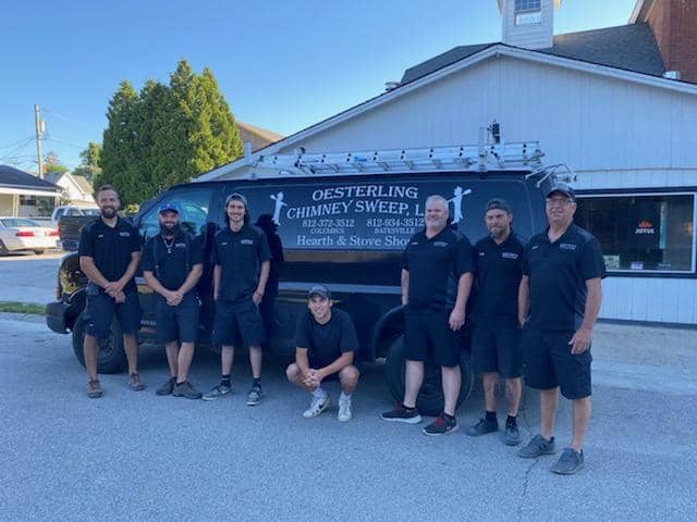 The Oesterling Chimney Sweep team standing in front of the company van
